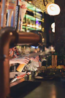 Friendly female bartender smiling warmly behind the counter.