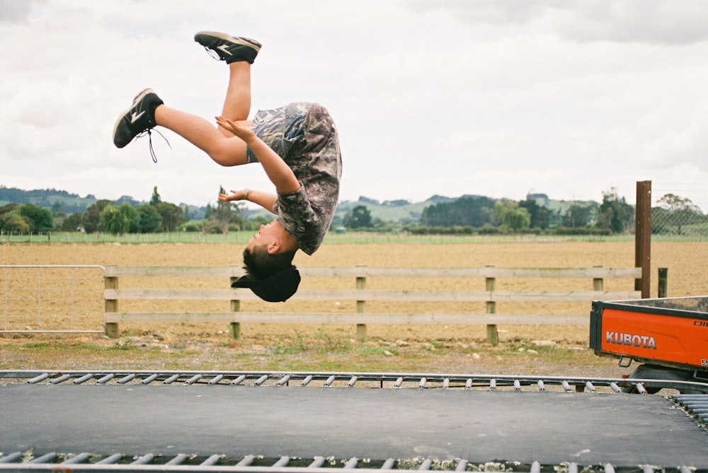 girl jumping in road during daytime