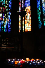 Colorful stained glass windows casting light on the altar.