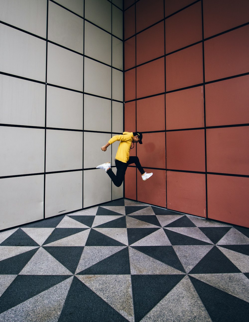 jumping man between corner of building