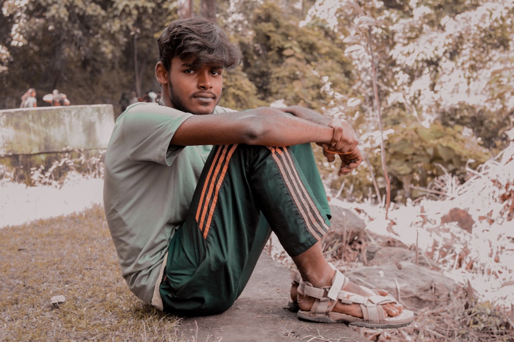 man sitting on ground during daytime