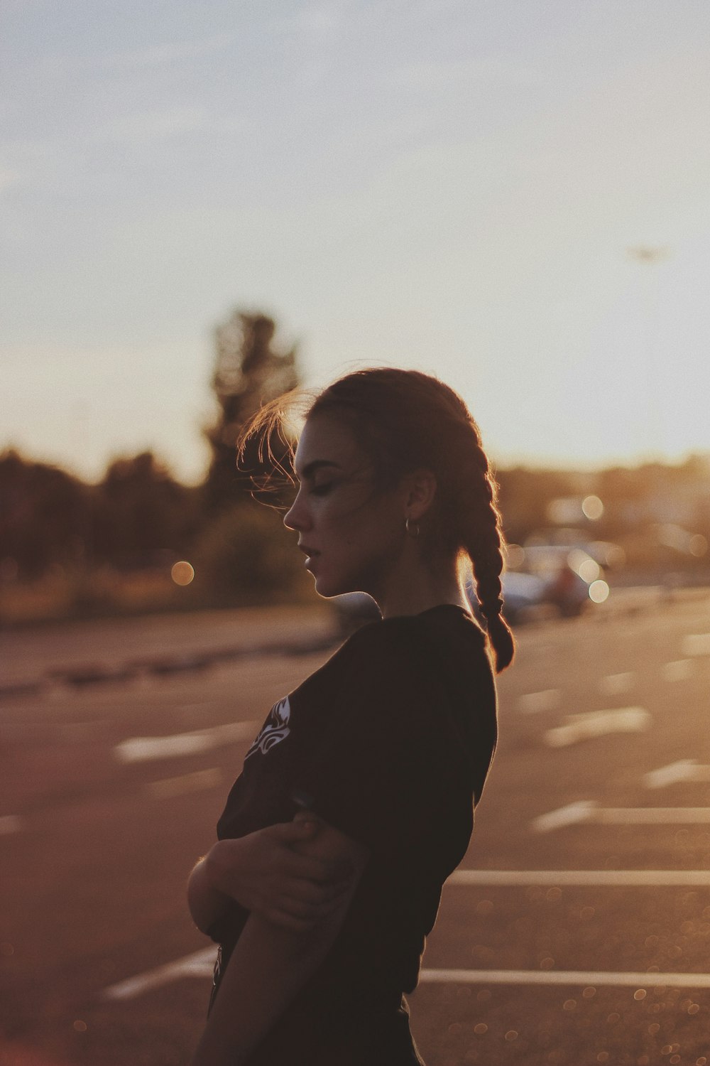 close-up photography of woman standing on parking lot