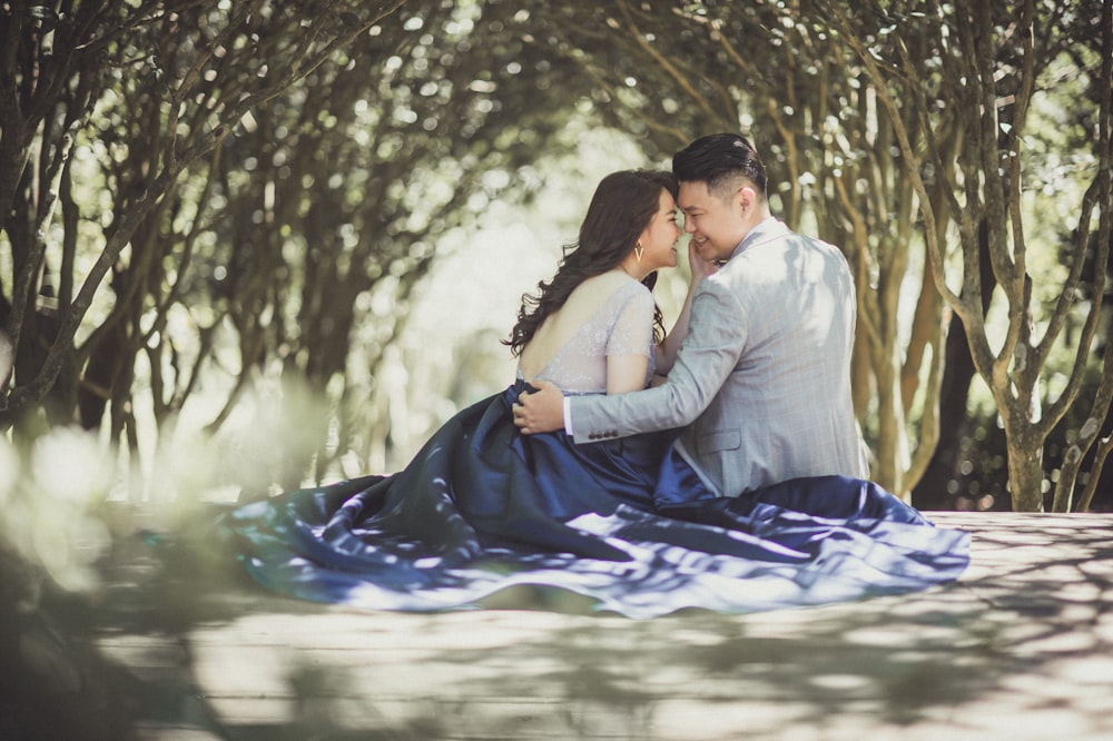 man and woman face to face under tunnel tree at daytime