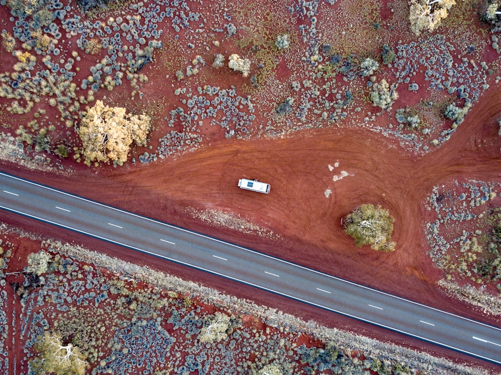 aerial view photography of white vehicle beside road