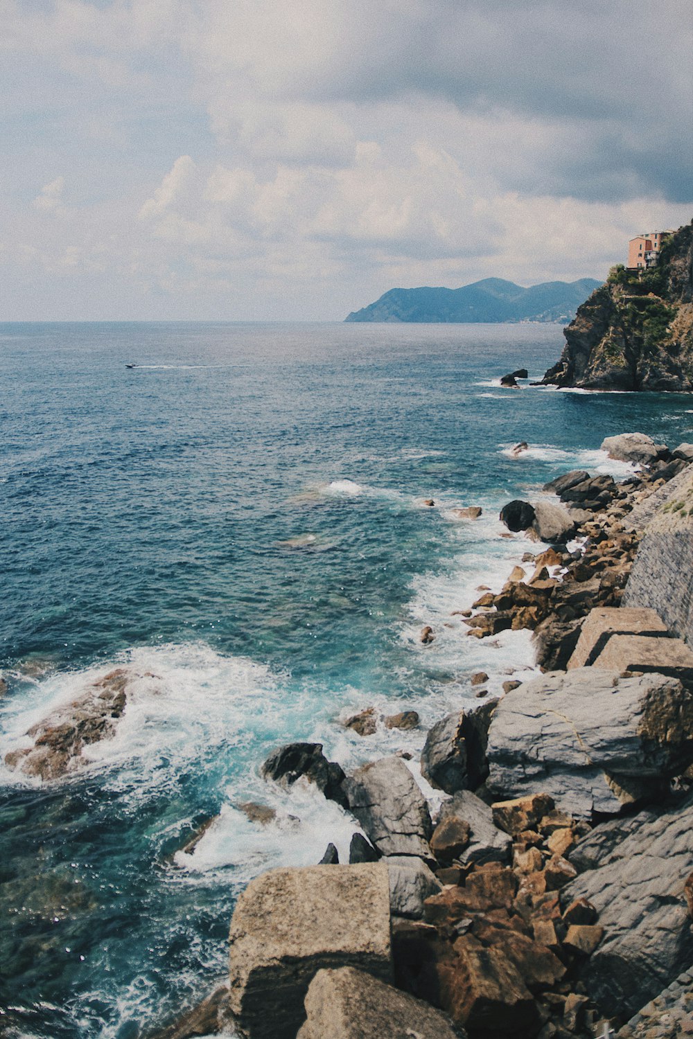 gray rocks beside body of water