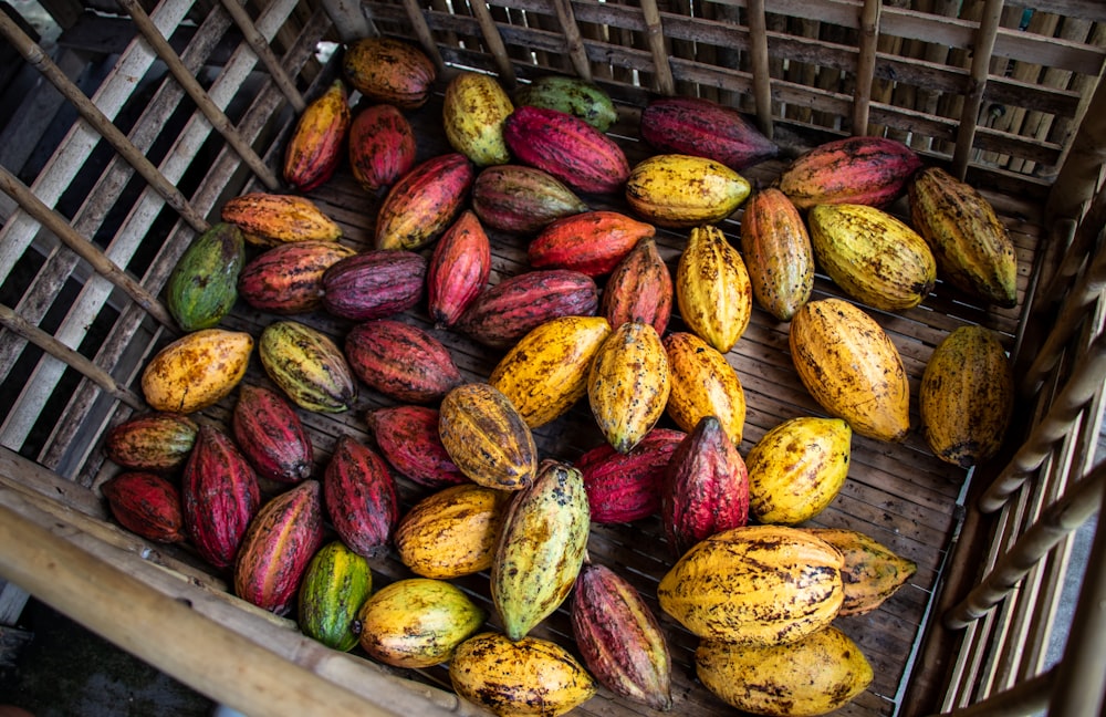 a crate filled with lots of ripe and unripe fruit