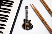 black electric guitar on white surface