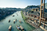 bird's eye view photography of boats river between houses