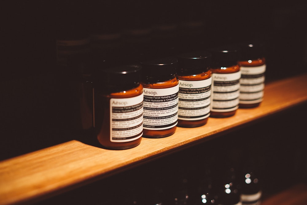 five brown and white glass bottles