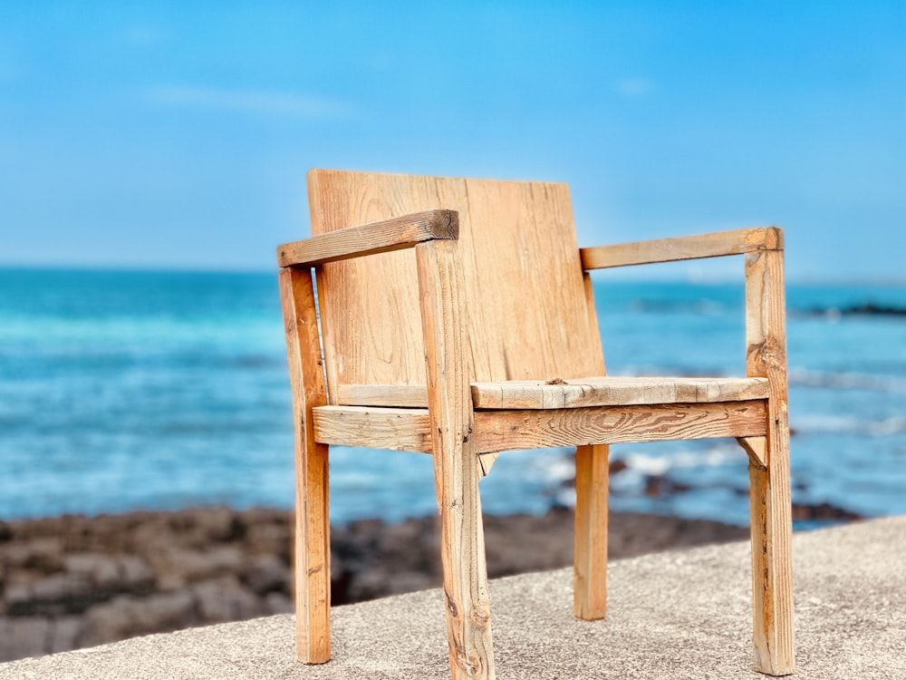 brown wooden chair near body of water