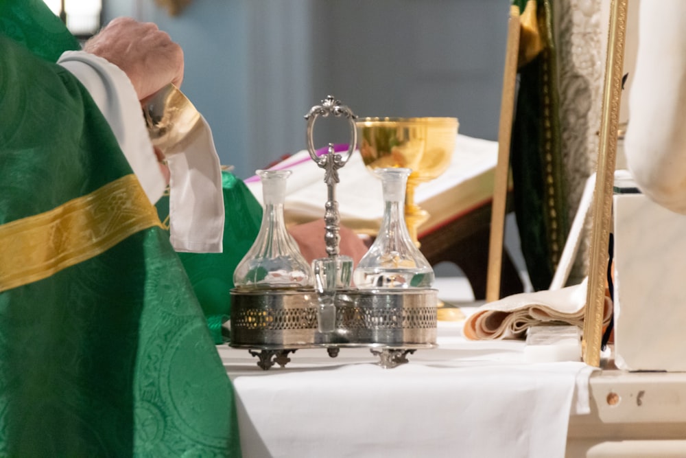 priest wiping chalice
