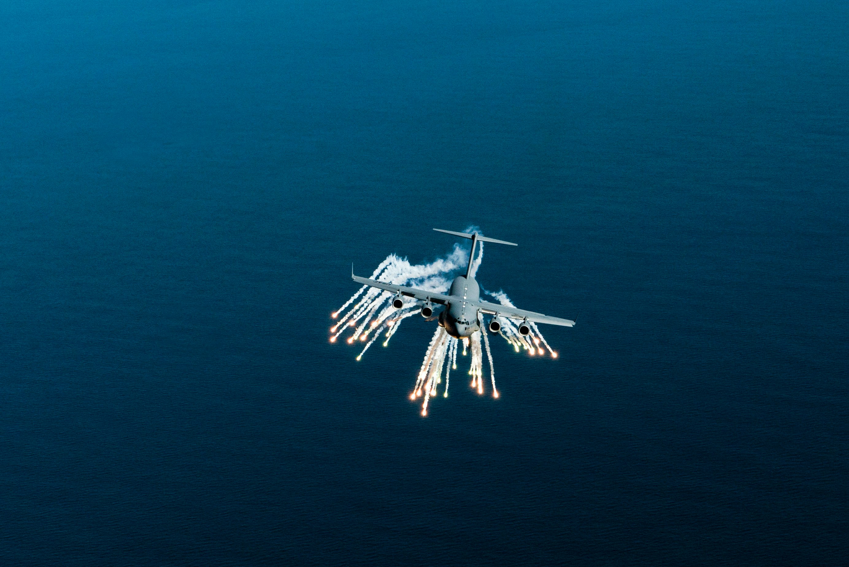 A C-17 Globemaster III aircraft deploys flares off the coast of Charleston, SC.