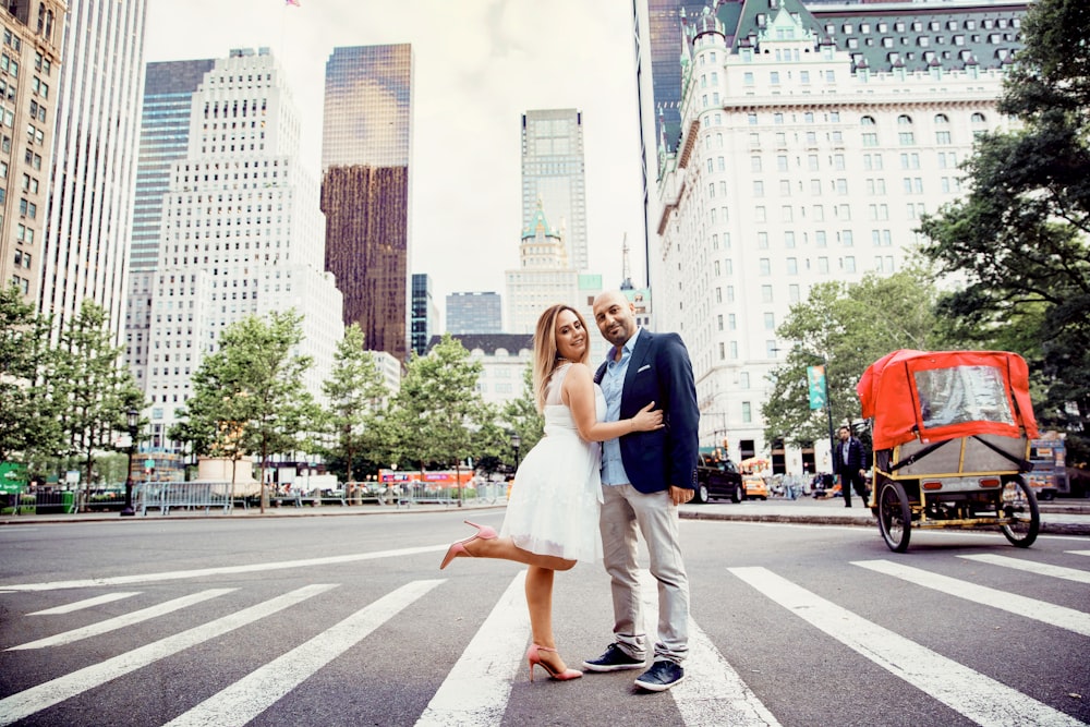 woman and man standing on pedestrian lane