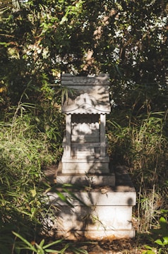 An ancient shrine surrounded by vibrant flora.