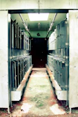 Wide aisle between rows of secure storage lockers in the facility.