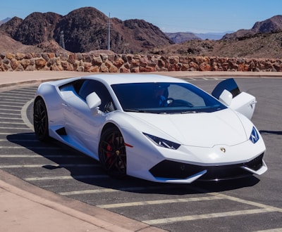 A stunning car parked in a scenic landscape.