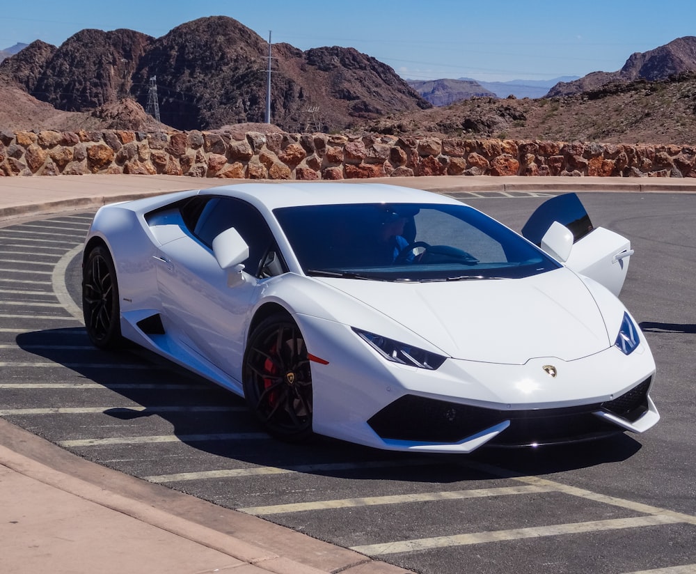 white sport car park at the street