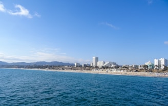 A vibrant collage showing a beach, city skyline, and mountain adventure.