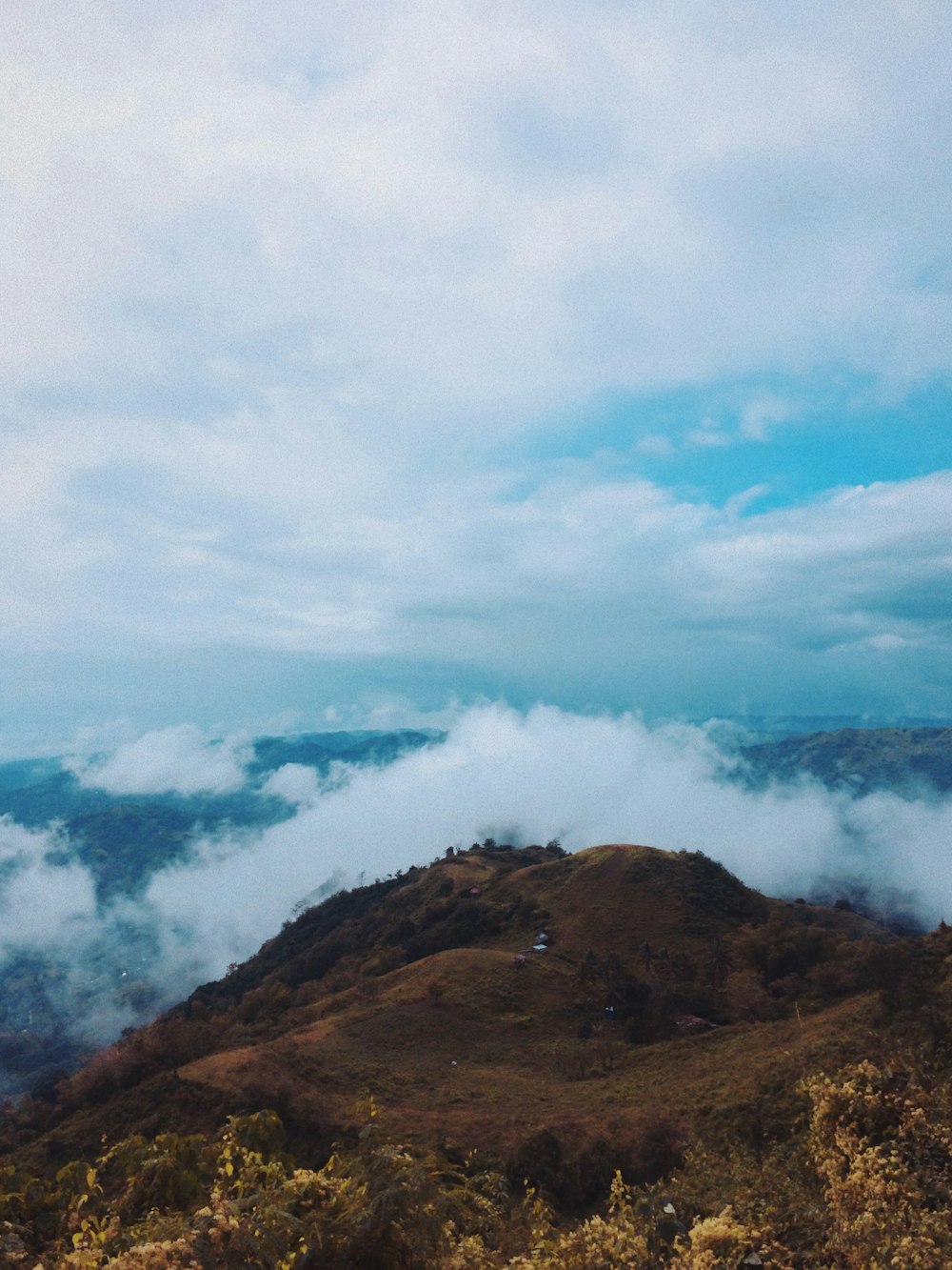 bird's eye view photography of mountain top near fogs