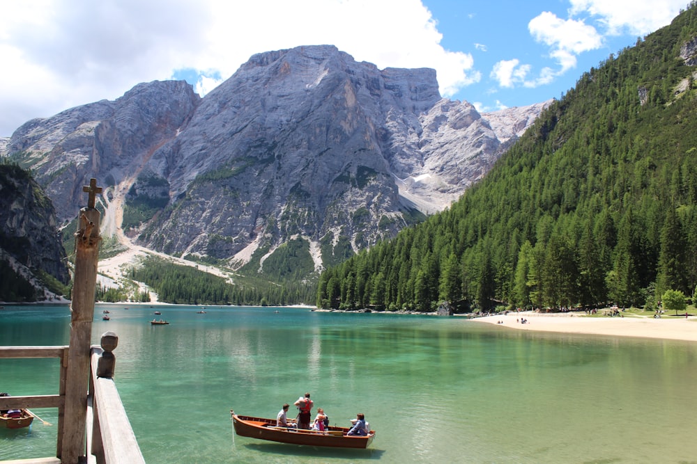 people on boat on body of water during daytime