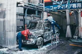 two men washing black SUV