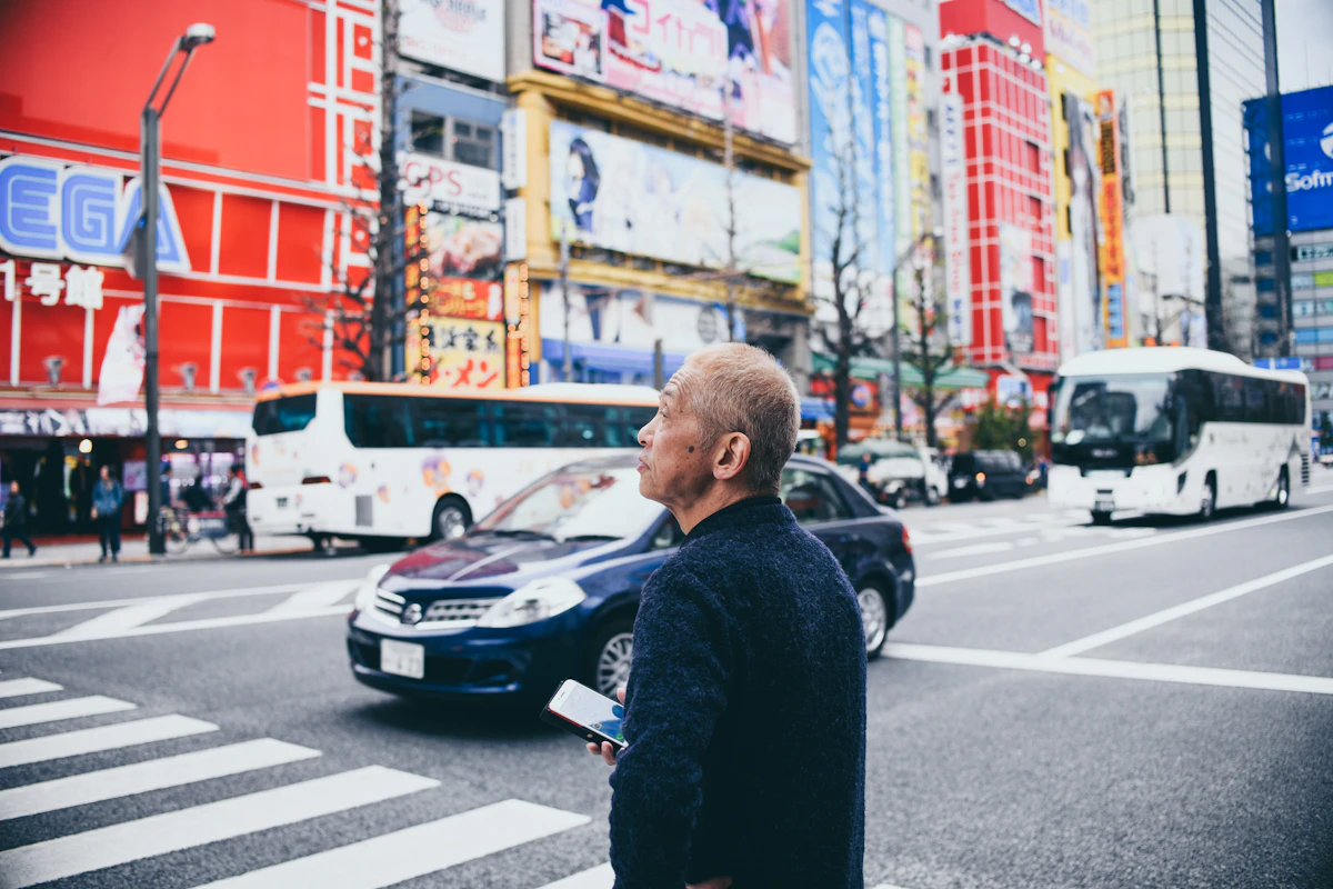 man standing on crosswalk near vehicles