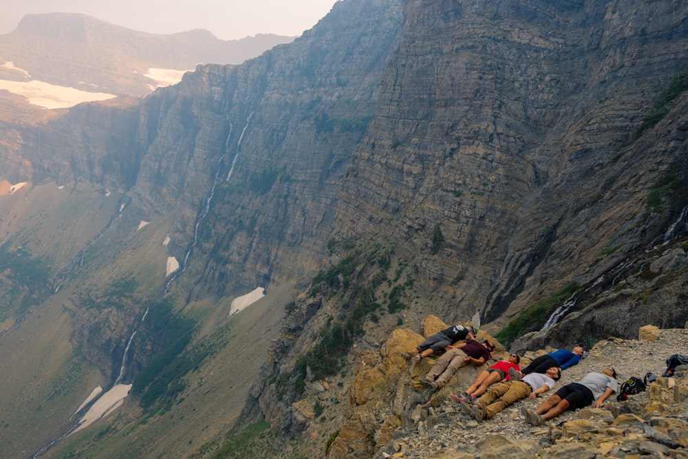 people lying on cliff