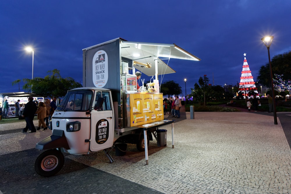 yellow and white auto rickshaw food stall