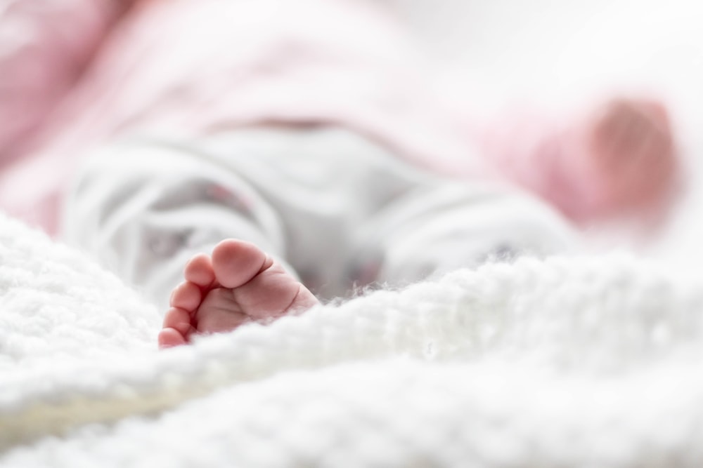 baby sleeping on bed