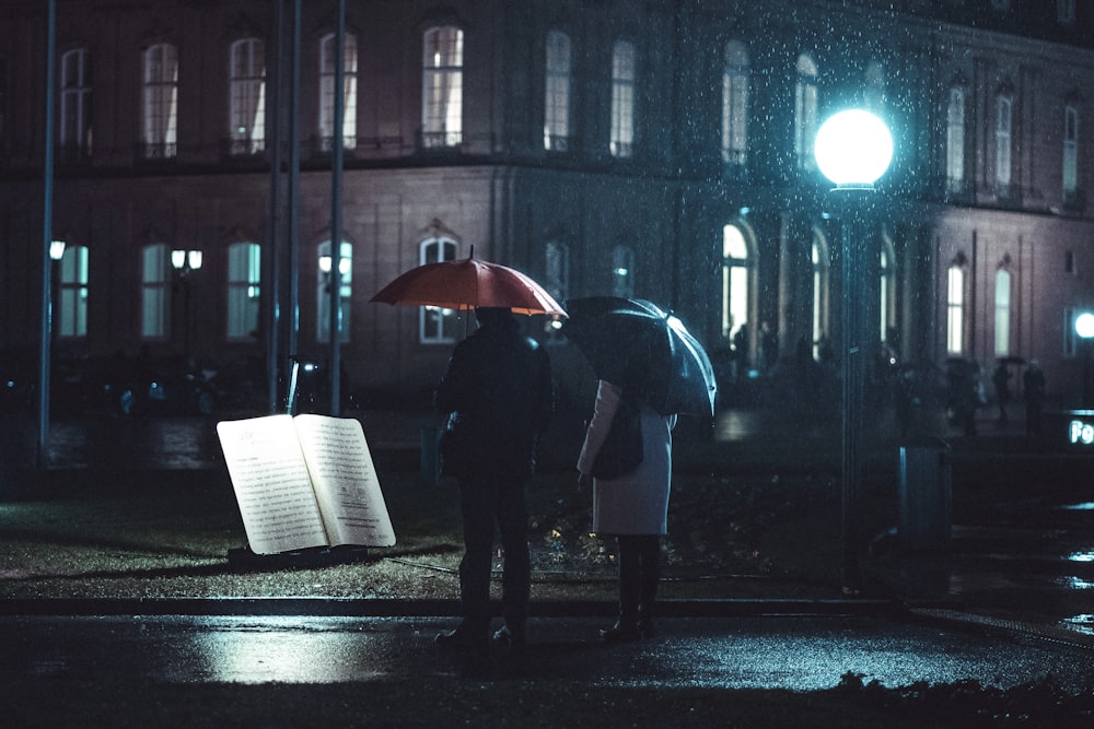 two persons under umbrella