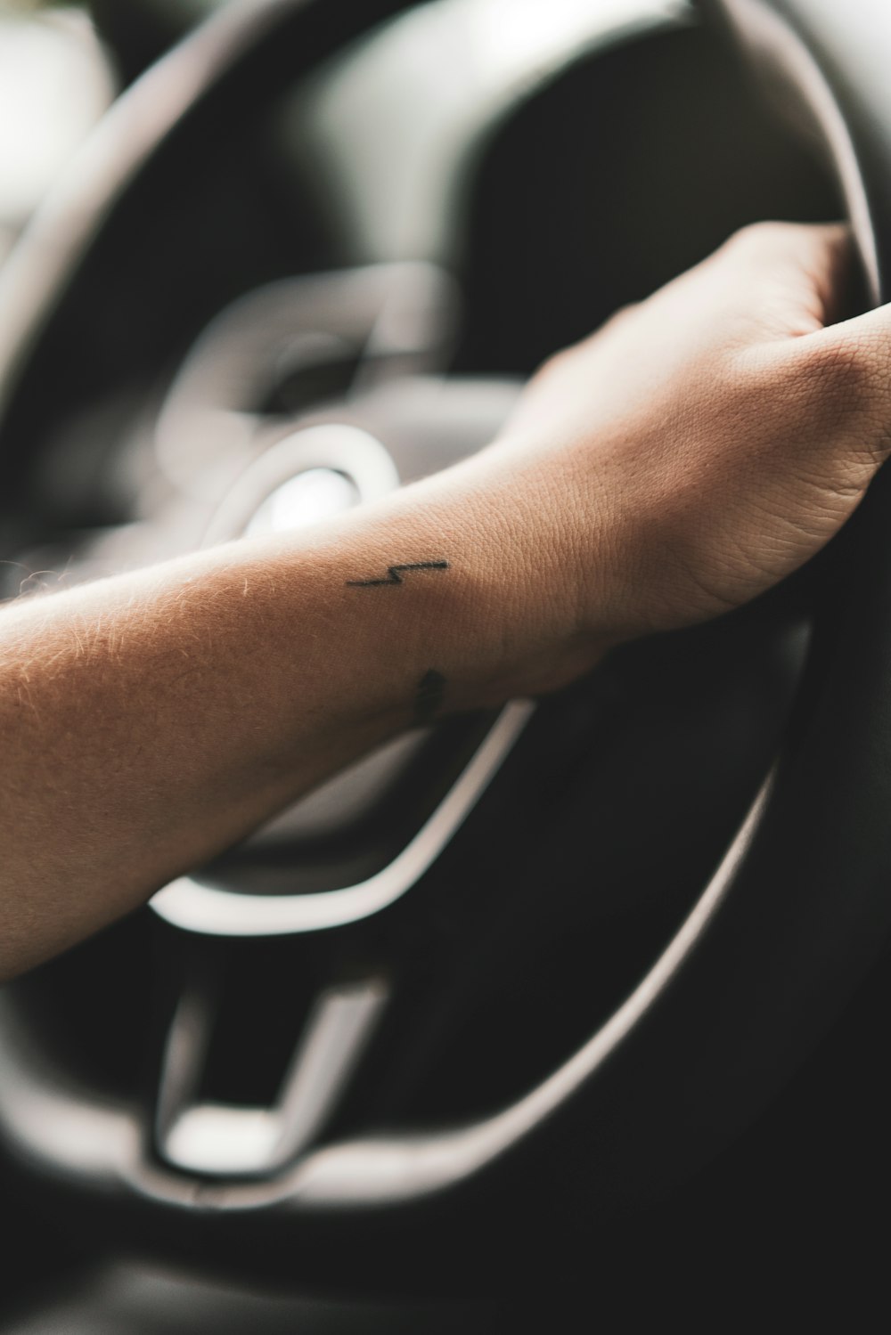 person holding steering wheel
