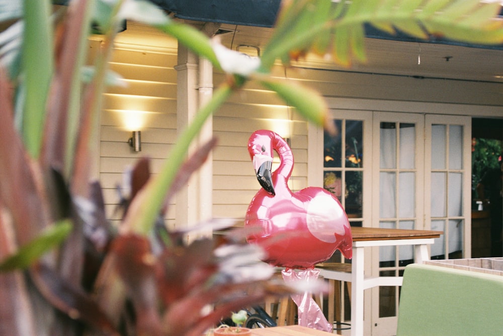 red flamingo decor in front of house