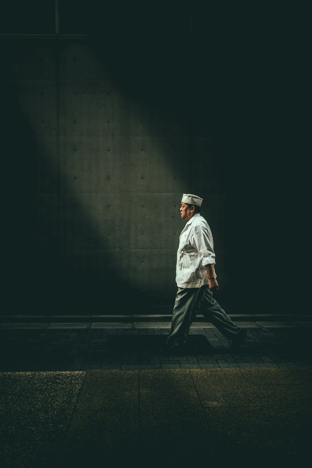 man in white shirt walking on street