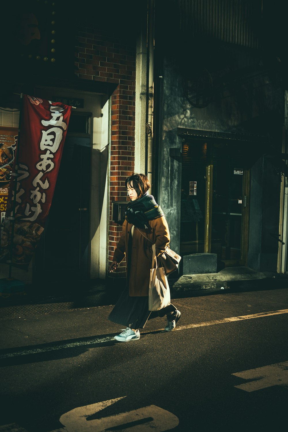 person walking beside building at night