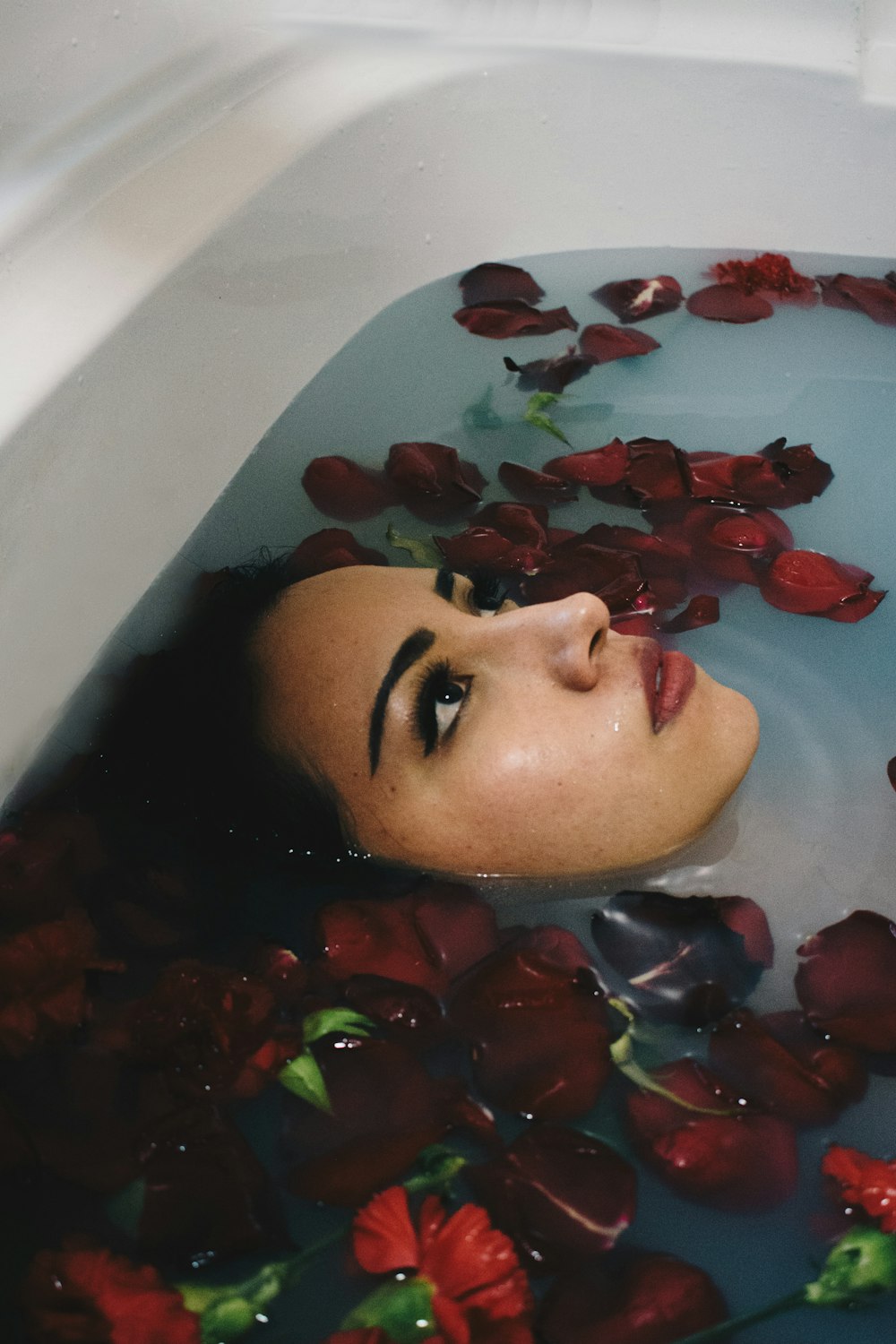 woman in bathtub with flowers