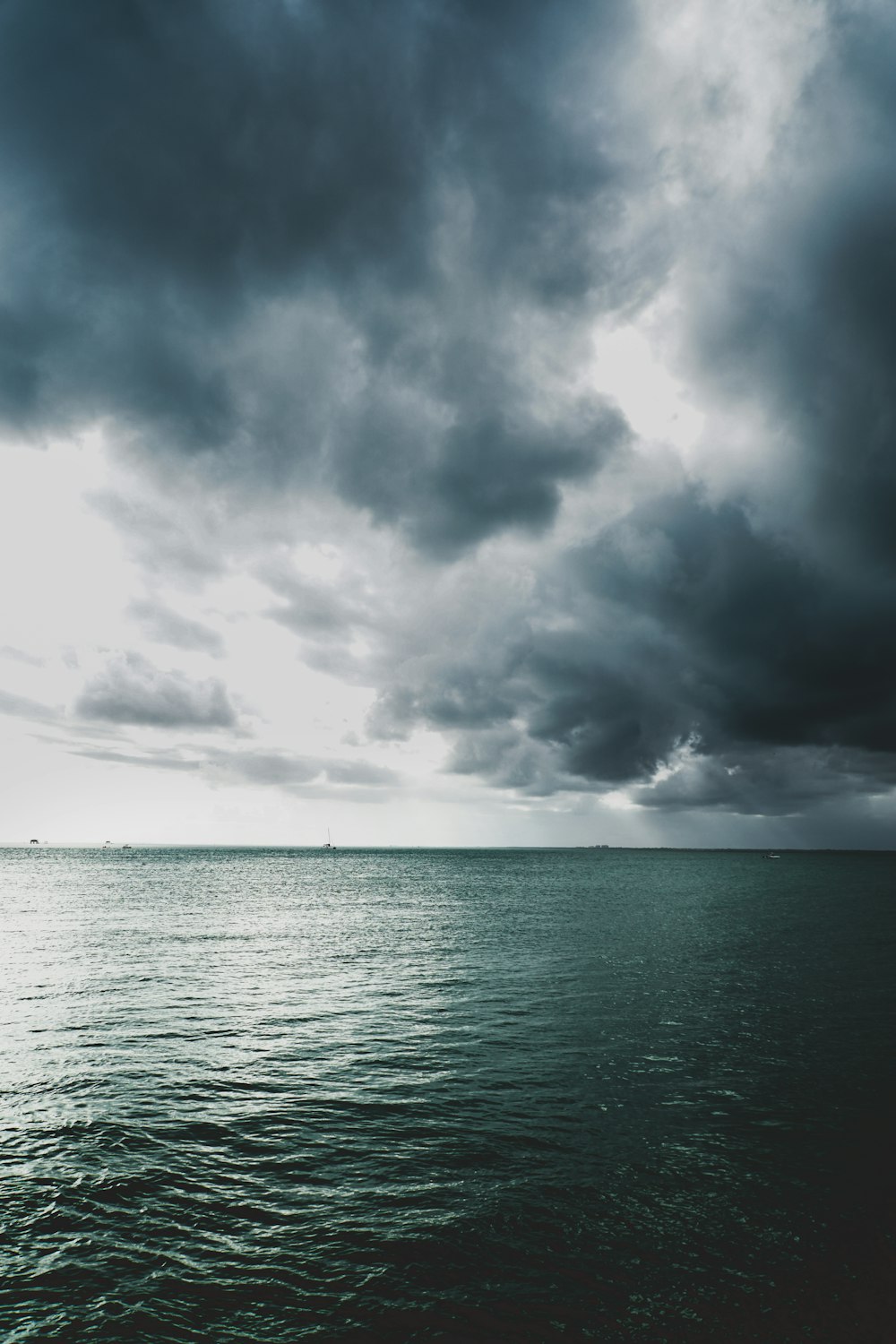 body of water under gray clouds