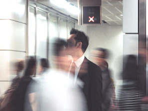 Man choosing a direction while people rush around him
