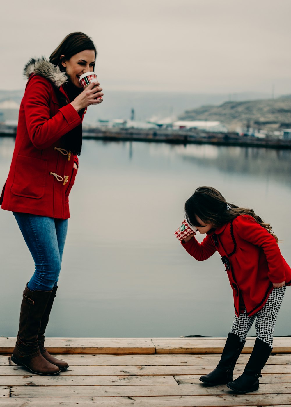 woman and girl drinking coffee during daytime