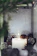 A serene photo of a lit candle surrounded by natural elements, evoking spiritual calm.