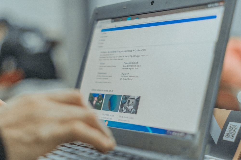 person in front of turned-on laptop computer