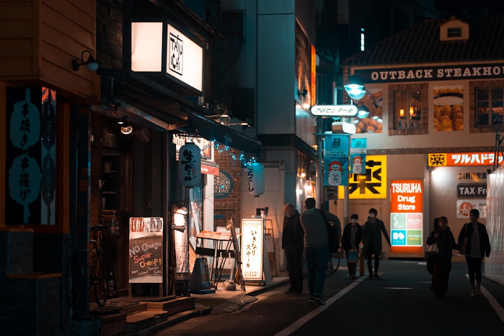 people walking on street at nighttime