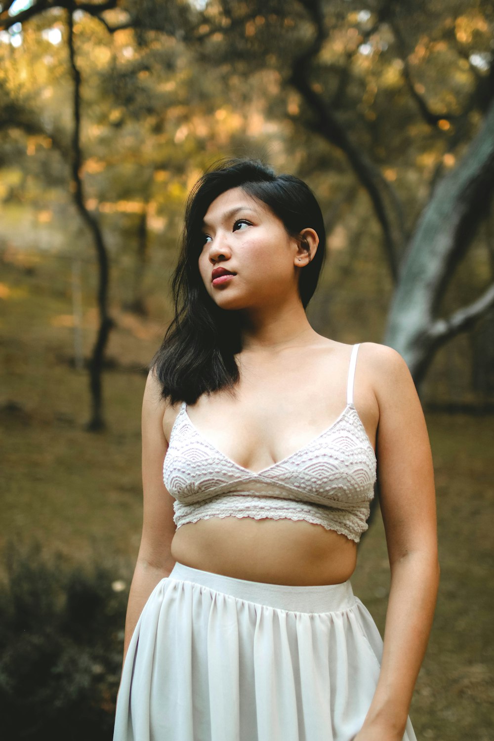 woman wearing bralette and skirt