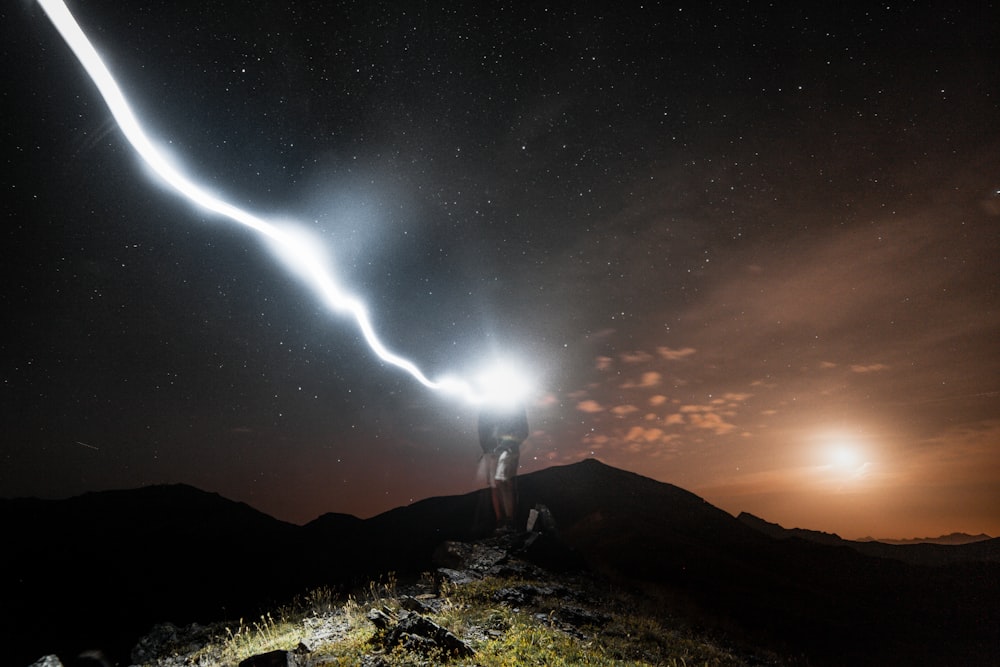 man standing on cliff at night
