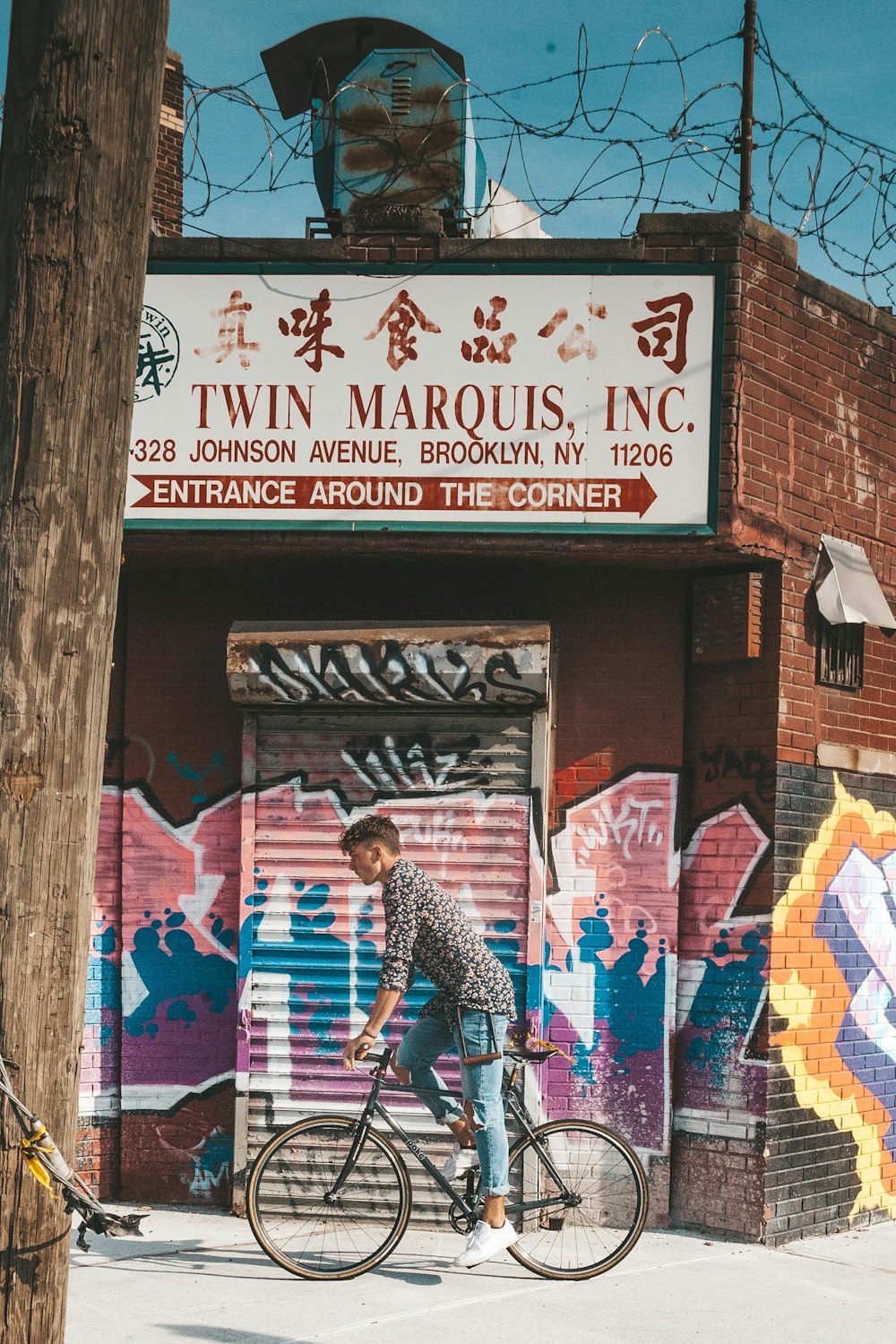 man biking near Twin Marquis, Inc. building