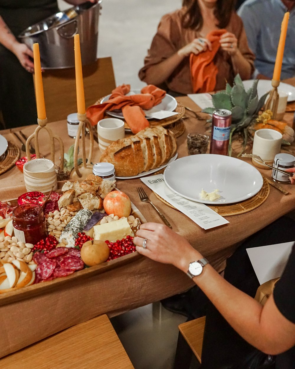 assorted cheeses, salami, and bread on table