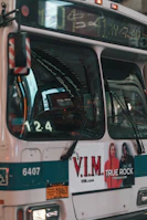 Exterior shot of a busy urban bus featuring bright, eye-catching digital ads.
