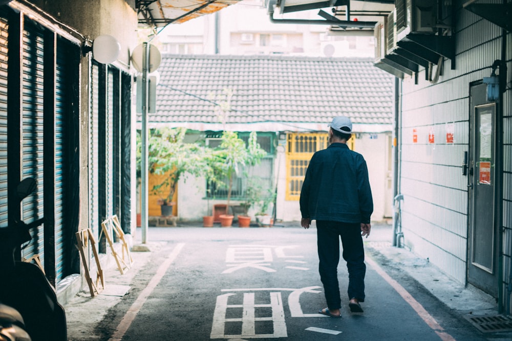 man standing between houses