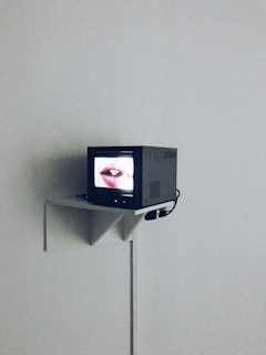 A fixed TV mount installed in a cozy bedroom.