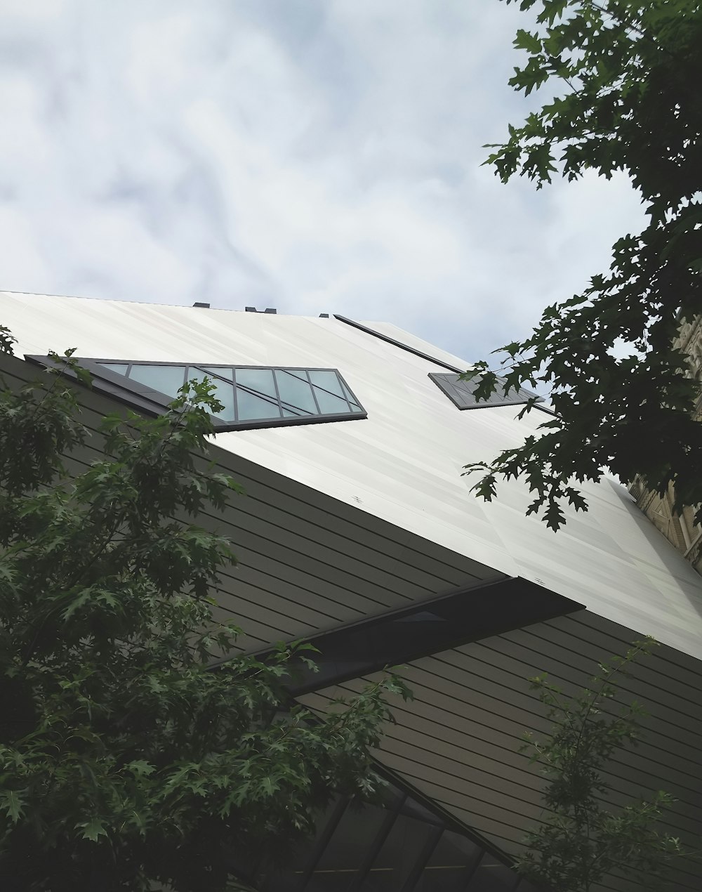 low-angle photo of building under gray sky