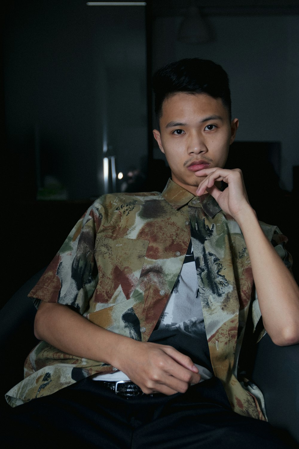 man in white and green floral short-sleeved button-up shirt